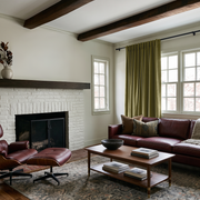 Moss Green Velvet Back Tab Curtains in a Rustic Living Room with a White Brick Fireplace and Burgundy Leather Sofa