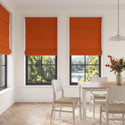 Burnt Orange Linen Cordless Roman Blinds in a Modern Dining Room with Cream Plaster Walls and a Wooden Dining Table
