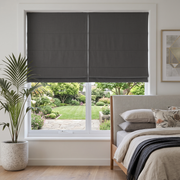 Dim Grey Roman Blinds in a Modern Bedroom with Neutral Walls and a Beige Upholstered Bed