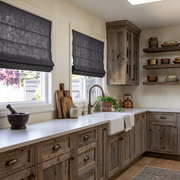 Dim Grey Linen Roman Blinds in a Rustic Kitchen with Natural Wood Cabinetry - Cotton Lining