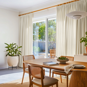 Ecru Heavy Weight Linen Pencil Pleat Curtains for Sliding Door in a Modern Dining Room with Wood Furniture, Cane Chairs, and Garden View - Cotton Lining
@Heading: Pencil Pleat
