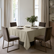 Ecru Square Heavy Weight Linen Tablecloth in a Contemporary Dining Room with Floor-to-Ceiling Curtains and Taupe Upholstered Chairs