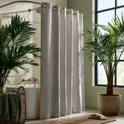 Natural Linen Hookless Shower Curtain in a Tropical Bathroom with Textured Beige Walls