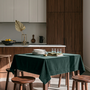 Hunter Green Square Velvet Tablecloth in a Contemporary Kitchen with Walnut Cabinetry and Wooden Stools