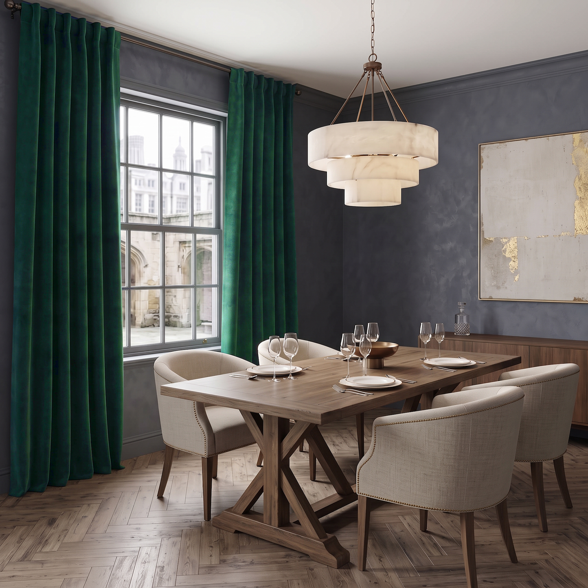 A sophisticated dining room with charcoal-gray walls, rich emerald curtains, a wooden trestle table, beige upholstered chairs, elegant glassware, and a sculptural tiered chandelier