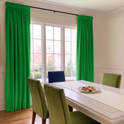 Bright dining room with vivid green rod-pocket curtains, contemporary furniture, and natural light.
