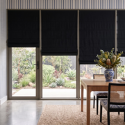 Black Roman Blinds in a Dining Room with Blue Stripe Wallpaper and Wooden Dining Table