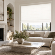 Heavy Off-White Roman Blinds in a Modern Living Room with Off-White Walls and a Stone Coffee Table