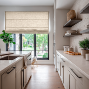 Cream Linen Kitchen Roman Blinds in a Bright Kitchen with White Cabinetry - Blackout Lining
