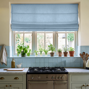 Sky Blue Linen Roman Blinds in a Cozy Cottage Kitchen with Pale Blue Tile - Blackout Lining