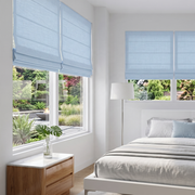 Sky Blue Cordless Linen Roman Blinds in a Modern Bedroom with White Walls and a White Bed Frame