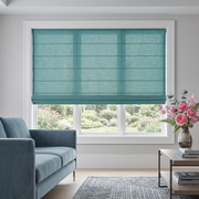 Aquamarine Roman Blinds in a Contemporary Living Room with Light Grey Walls, a Blue Velvet Sofa and a Modern Coffee Table.