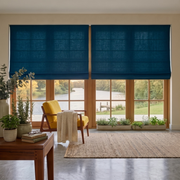 Peacock Blue Linen Cordless Roman Blinds in a Modern Living Room with Beige Walls and a Yellow Armchair