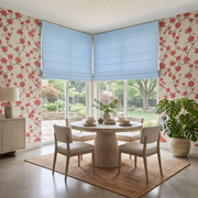 Sky Blue Cordless Linen Roman Blinds in a Modern Dining Room with Floral Wallpaper and a Round Dining Table