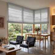 Stone Gray Linen Cordless Roman Blinds in a Contemporary Open-Plan Living and Dining Room with White Walls and Black Leather Armchairs