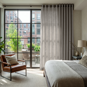 Stone Grey Linen Eyelet Bedroom Curtains in a Bright Bedroom with Balcony Greenery and Soft Beige Accents