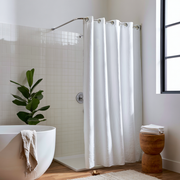 White Linen Hookless Weighted Shower Curtain in a Bright Bathroom with a White Tiled Wall