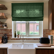 Forest Green Linen Roman Blinds in a Warm Rustic Kitchen with Exposed Brick