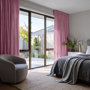 Dusty Rose Linen Pencil Pleat Curtains in a Cozy Bedroom with Soft Taupe Walls 