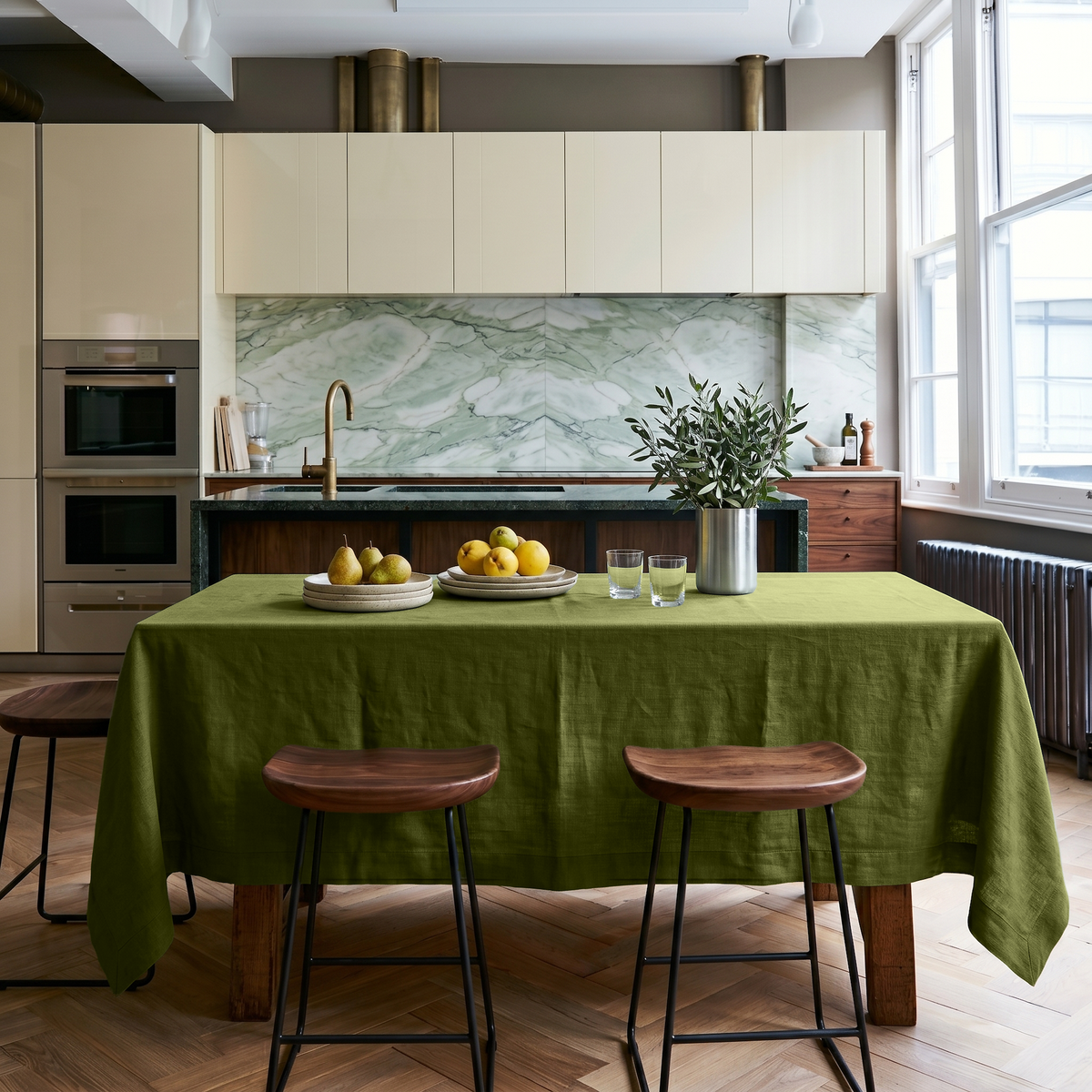 Moss Green Rectangular Linen Tablecloth in a Contemporary Kitchen with Marble Backsplash and Walnut Bar Stools