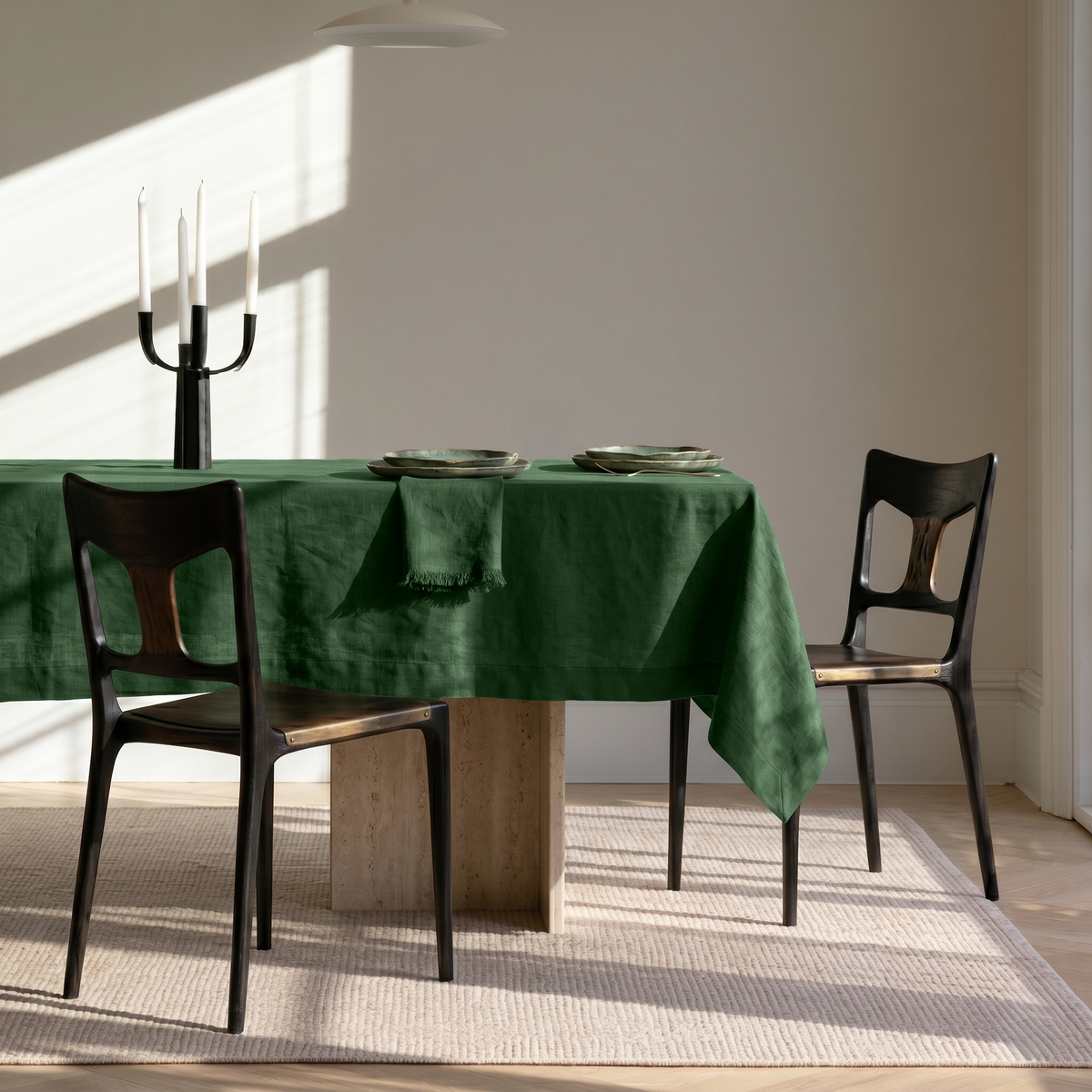 Forest Green Rectangular Linen Tablecloth in a Minimalist Dining Room with Sculptural Black Chairs