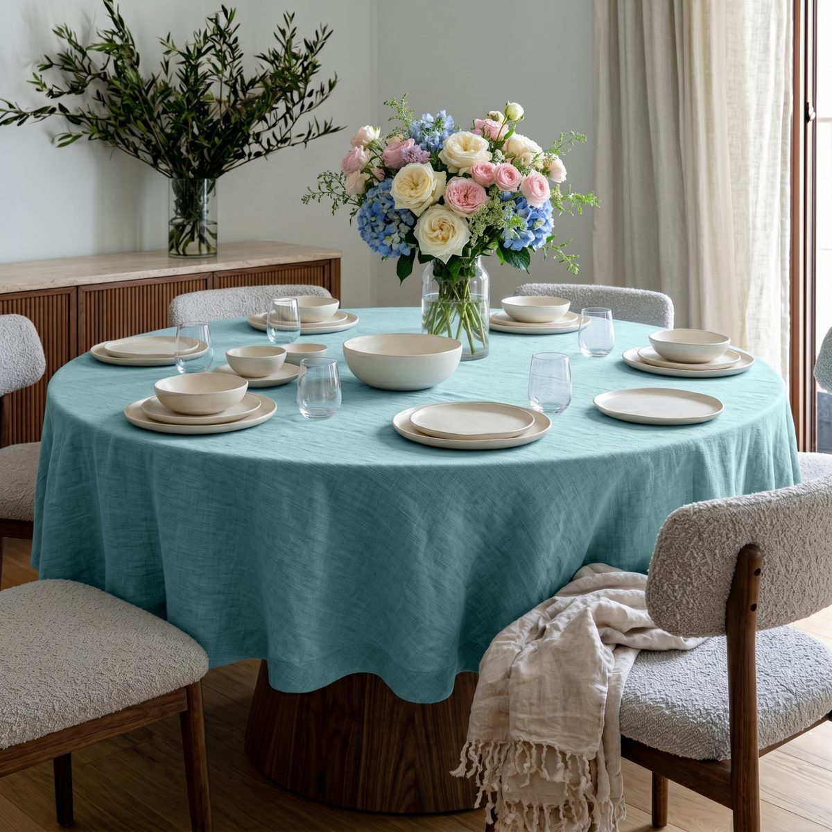 Aquamarine Blue Linen Round Tablecloth in an Elegant Dining Room with Fluted Walnut Cabinetry and Natural Wood Accents