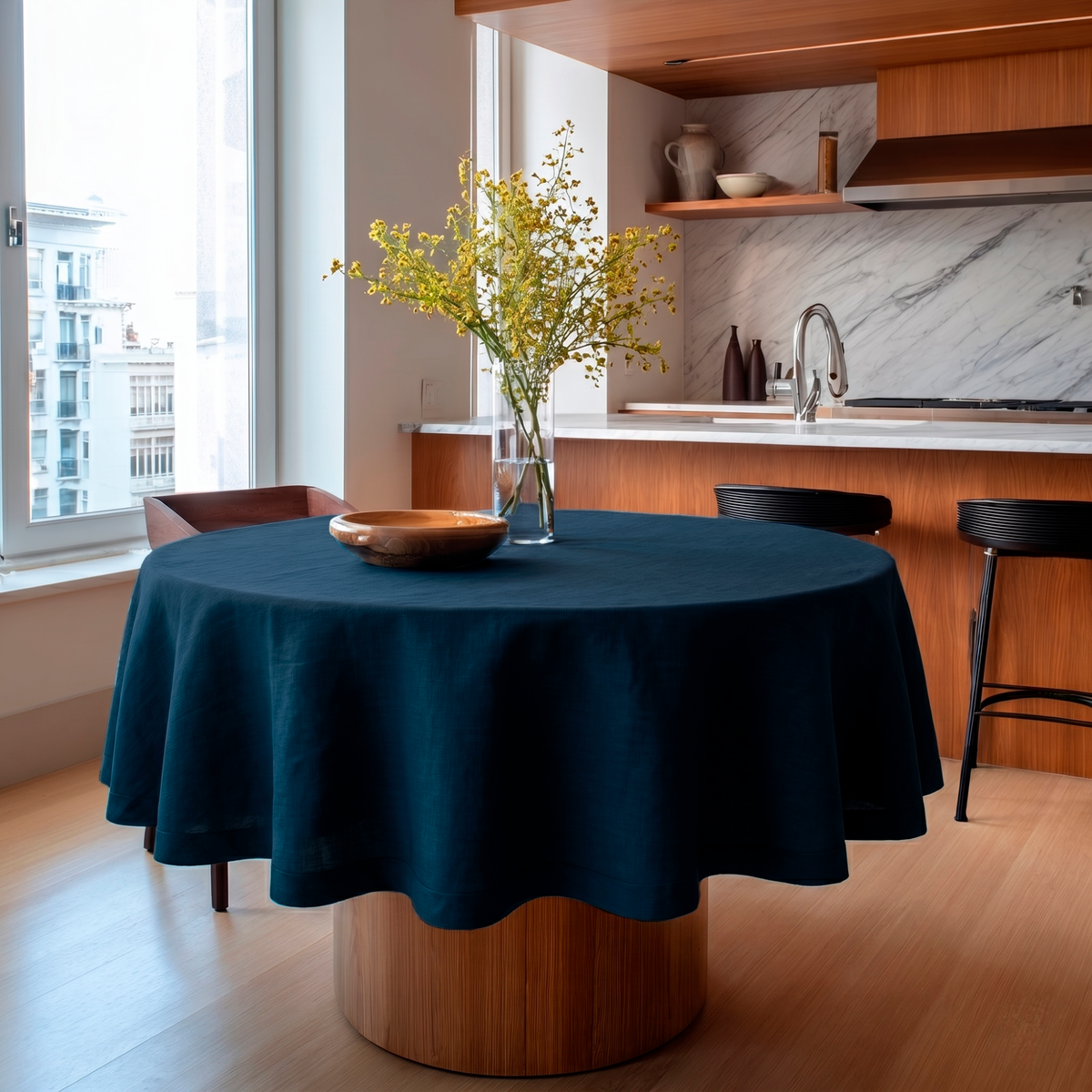 Peacock Blue Linen Round Tablecloth in a Modern Kitchen Dining Area with White Marble Walls