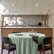 Mint Green Round Velvet Tablecloth in a Modern Kitchen with Marble Surfaces and Warm Wood Cabinetry Accents