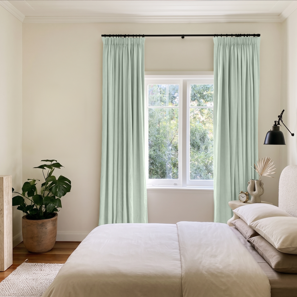 Mint Green Velvet Pencil Pleat Curtains in a Minimal Bedroom with Warm White Walls and White Bedding