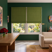 Moss Green Roman Blinds in a Modern Living Room with Dark Green Walls and Wooden Table
