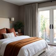 Natural Heavy Weight Linen Back Tab Curtains for Sliding Door in a Modern Bedroom with Taupe Walls, Rust Bedding Accents and Garden View
@Heading: Back Tabs