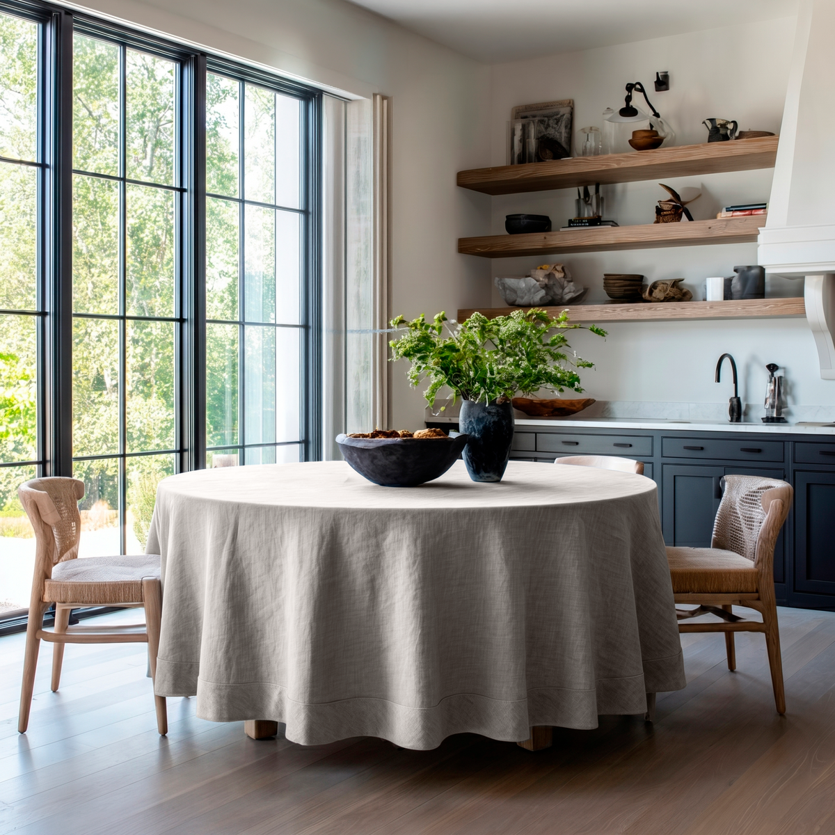 Natural Linen Round Tablecloth in a Modern Kitchen Dining Area with Black Framed Windows and Charcoal Accents