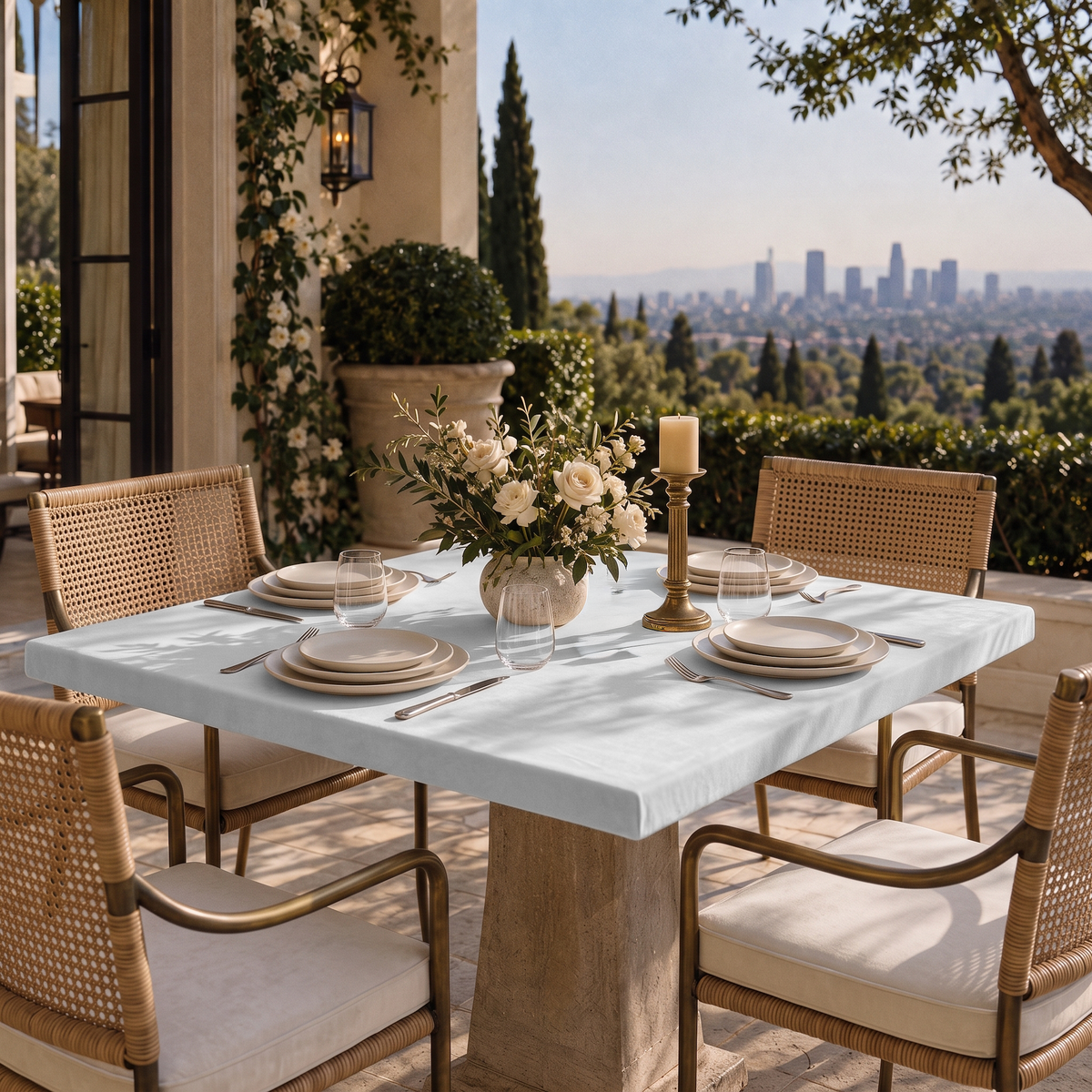 Off-White Fitted Square Velvet Tablecloth in a Mediterranean Patio Dining Area with Woven Chairs