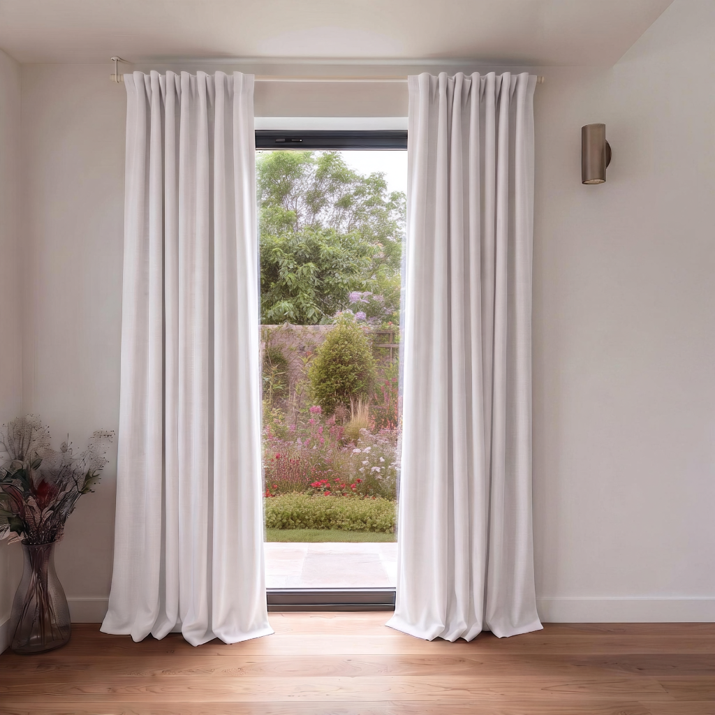 Off-White Heavy Weight Linen Back Tab Extra Long Curtains in a Minimalist Room with Garden Views and Warm Wood Flooring