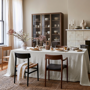 Off-White Rectangular Heavy Weight Linen Tablecloth in a Transitional Dining Room with Fireplace and Glass-Front Cabinet