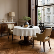 Off-White Heavy Weight Linen Round Tablecloth in a Classic Dining Room with Beige Paneled Walls and Dark Wood