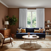 Off-White Velvet Pinch Pleat Blackout Curtains in a Living Room with Brown Walls