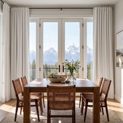 Off-White Linen Back Tabs Curtains In A Modern Dining Room With Light Gray Walls And A Wooden Dining Set Overlooking Scenic Mountain Views - Blackout Lining