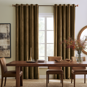 Sophisticated dining room with chocolate brown grommet curtains, rich wooden furniture, and warm décor.