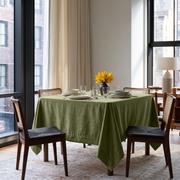 Olive Green Square Velvet Tablecloth in a Contemporary Dining Room with Floor-to-Ceiling Windows and Cane Chairs
