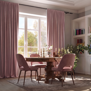 A refined dining room with floor-length blush-pink curtains, an ornate dark-wood table, matching upholstered chairs, built-in bookshelves, greenery, and warm natural light