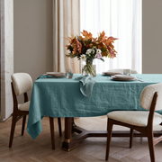 Aquamarine Blue Rectangular Linen Tablecloth in a Contemporary Dining Room with Bouclé Chairs