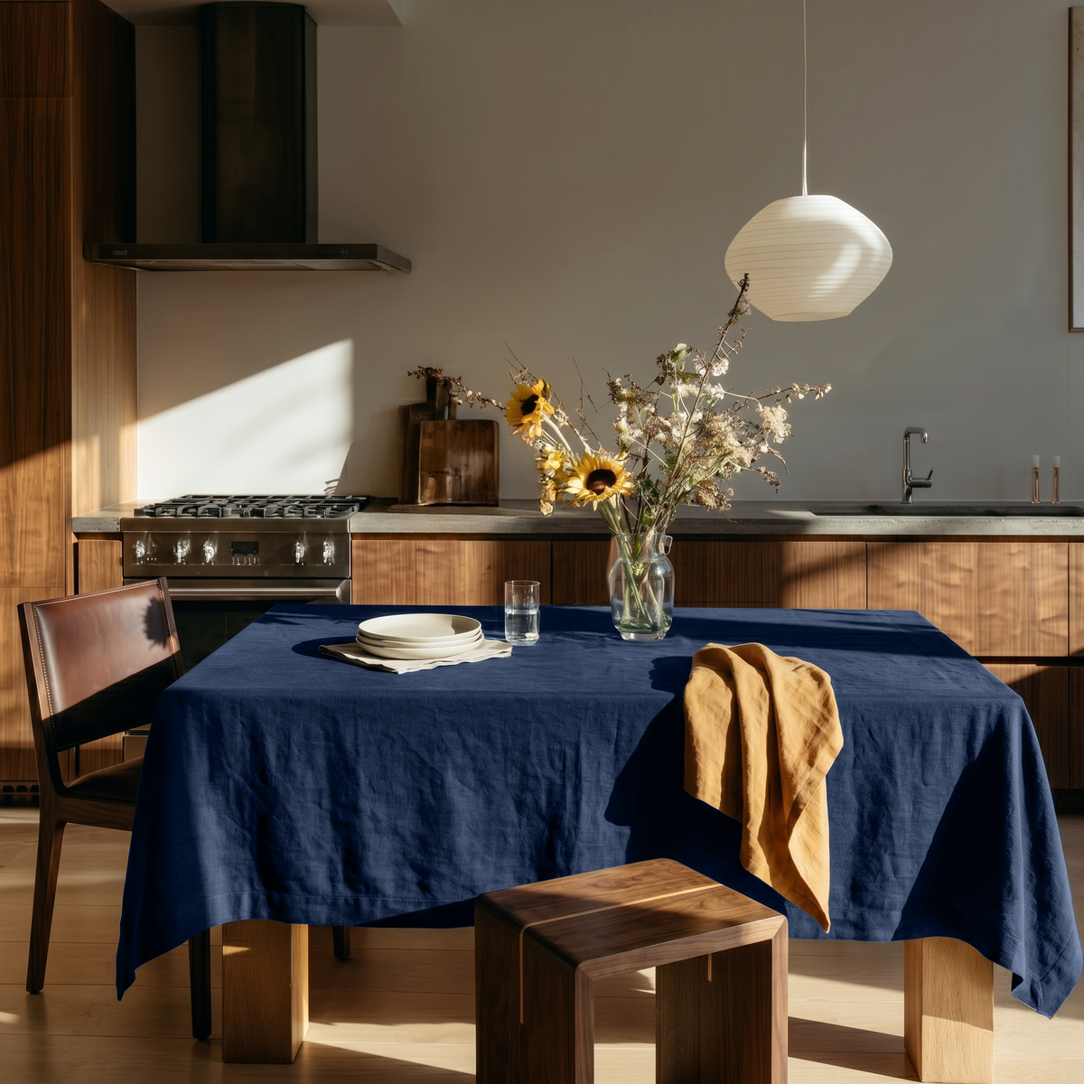 Royal Blue Rectangular Linen Tablecloth in a Modern Kitchen with Walnut Cabinetry and Sunflower Arrangement