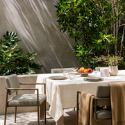 Cream Rectangular Linen Tablecloth in a Modern Outdoor Dining Area with Metal Armchairs