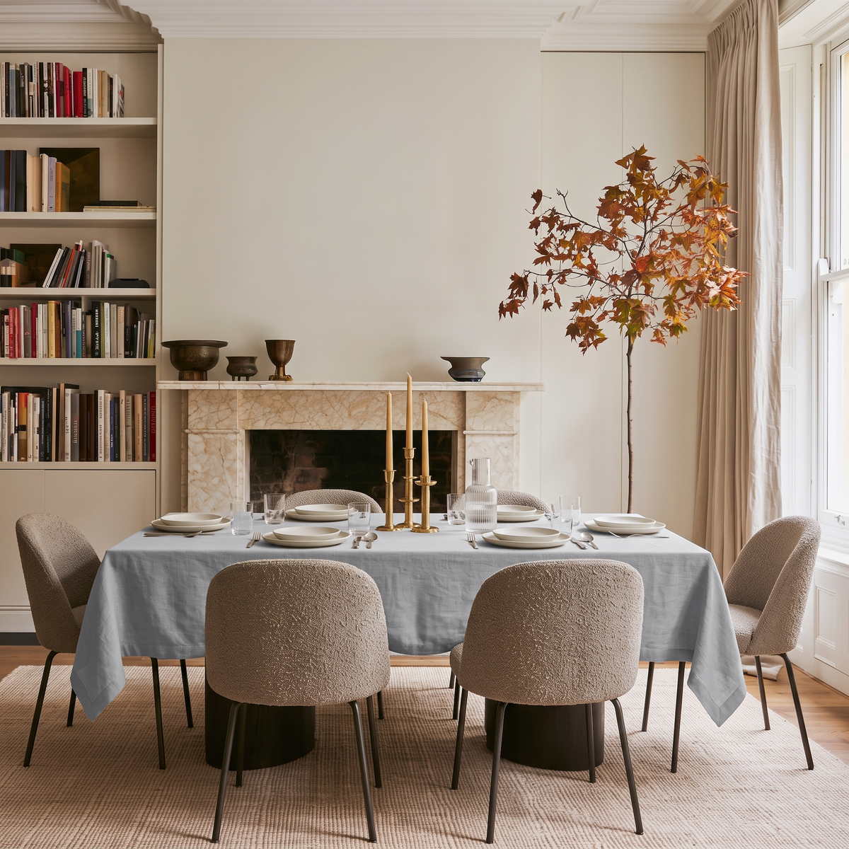 Stone Grey Rectangular Linen Tablecloth in a Contemporary Dining Room with Marble Fireplace and Built-In Bookshelves