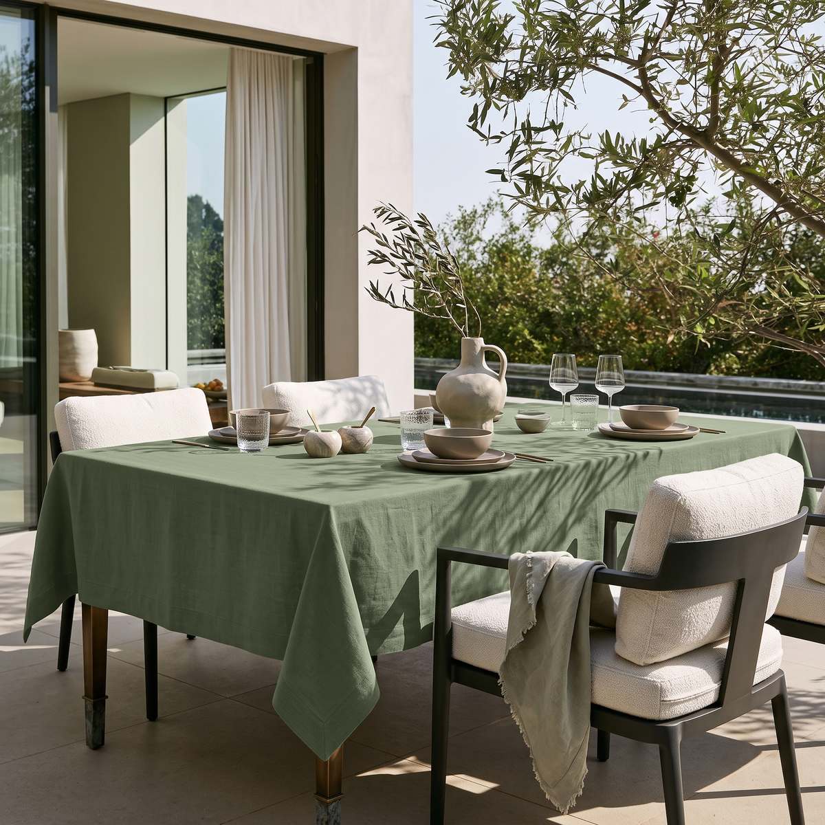 Asparagus Green Rectangular Linen Tablecloth on a Modern Outdoor Terrace with Cushioned Armchairs