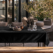 Black Rectangular Velvet Tablecloth in a Contemporary Patio Dining Area with Woven Lounge Chairs