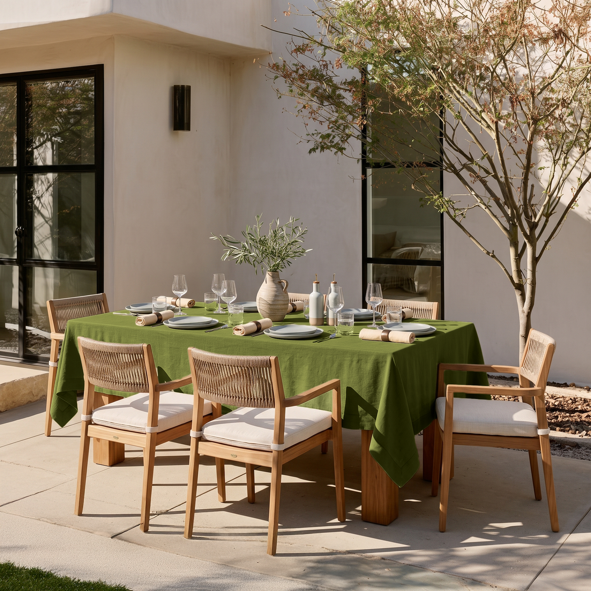 Moss Green Rectangular Linen Tablecloth on a Contemporary Outdoor Patio with Woven Chairs