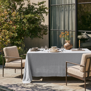 Stone Grey Rectangular Linen Tablecloth in a Modern Outdoor Dining Area with Metal Armchairs