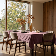 Pink Rectangular Velvet Tablecloth in a Contemporary Dining Room with Floor-to-Ceiling Windows and Walnut Wall Paneling